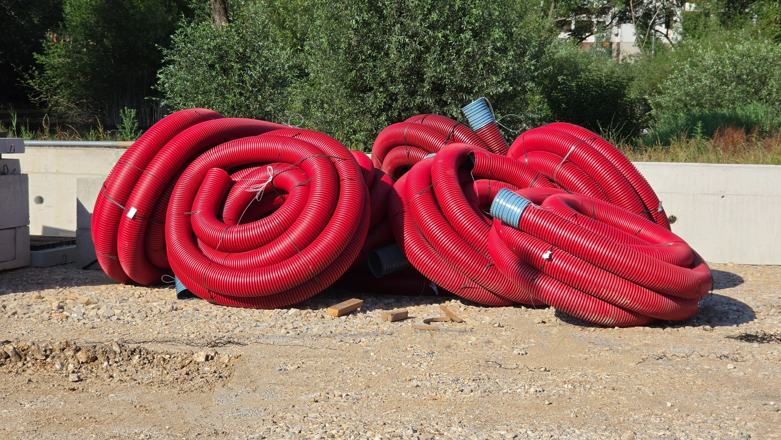 Large coils of utility conduit at a construction site
