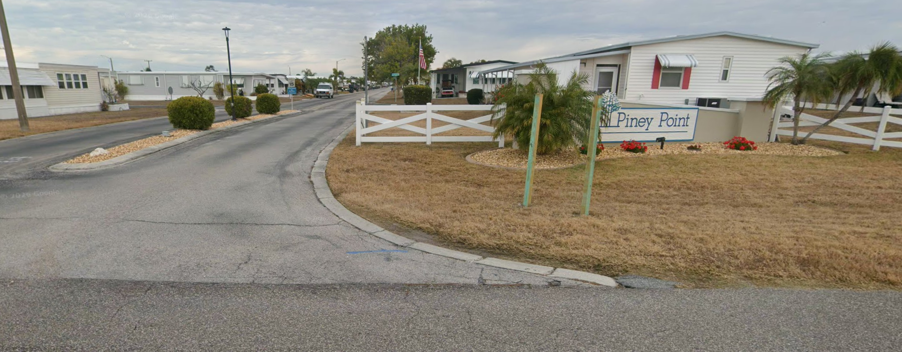 Entrance sign and roadway at Piney Point MHP in Palmetto