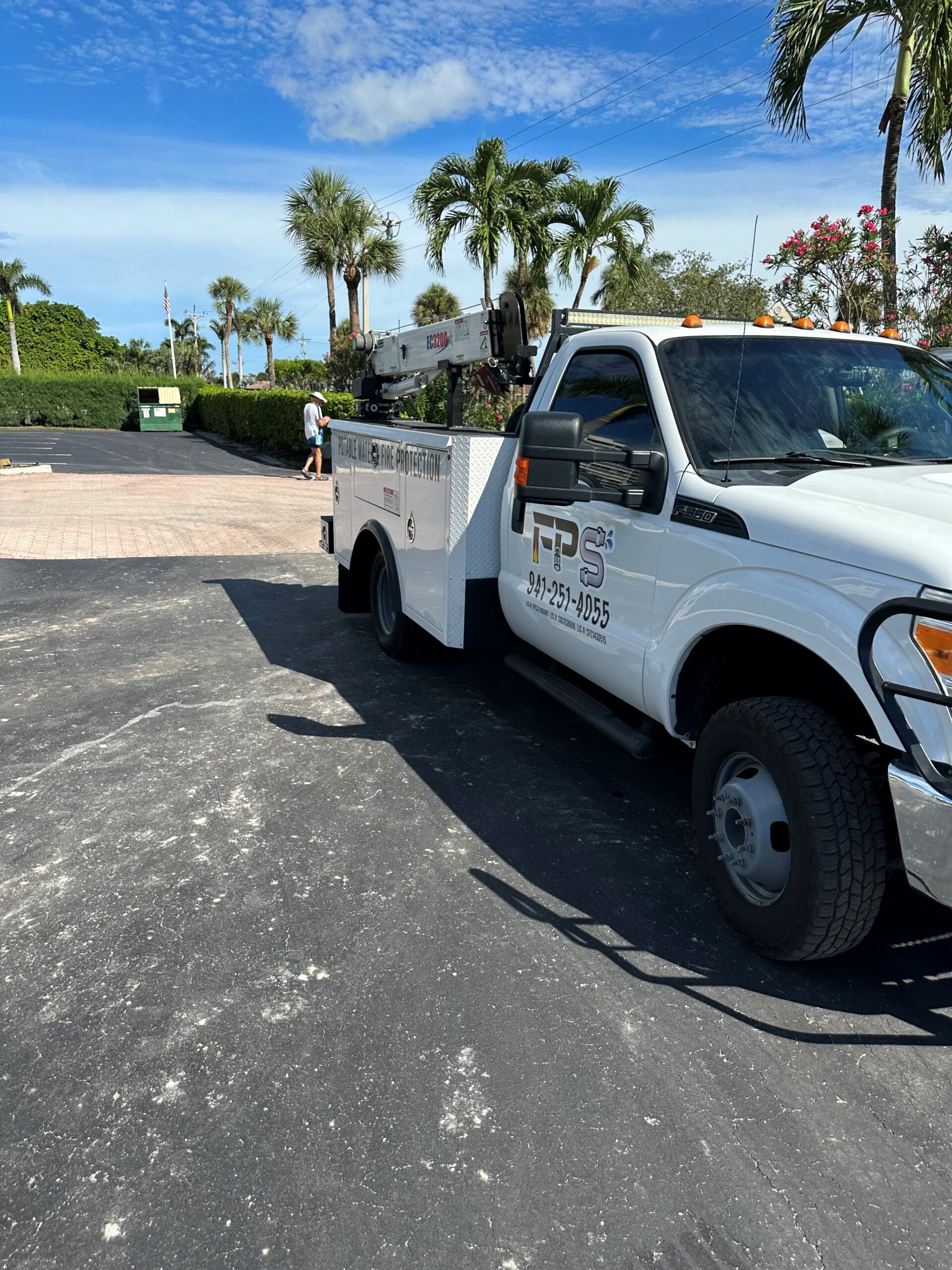 Florida Piping Solutions service truck at a jobsite with palm trees and blue sky